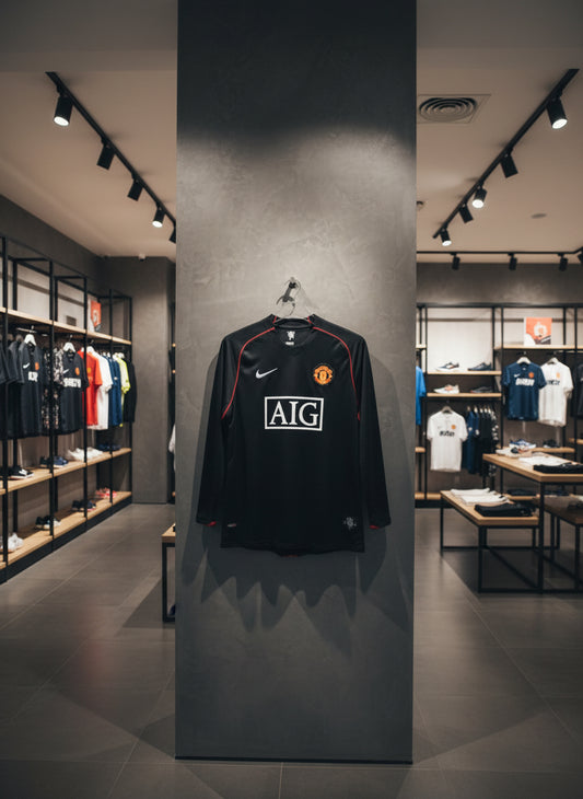 Manchester United jersey with AIG logo in a store setting